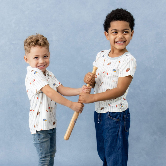 Two boys standing beside one another both holding a miniature wooden bat wearing the Toddler Basic Tee and Short Sleeve toddler Polo in Home Run