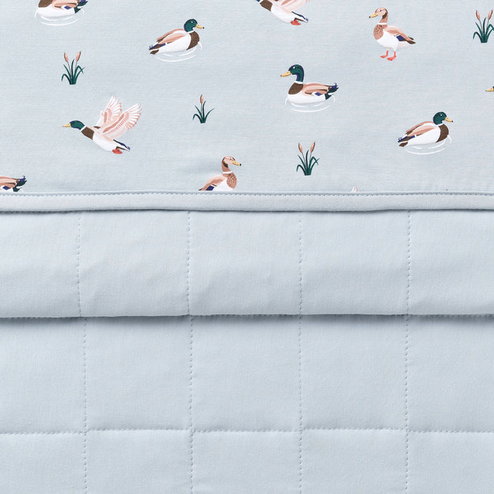 Close up of the Toddler Blanket in Mallard Duck 1.0 showing the light blue quilted backing and patterned smooth to player