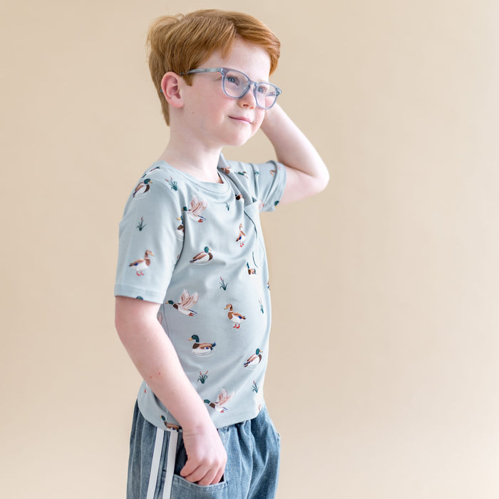 Boy posing looking off to the side wearing the Toddler Crew Neck Tee in Mallard Duck