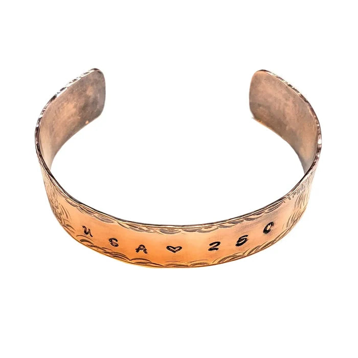 Copper bracelet with engraved USA 250 on a white background