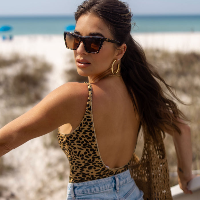 lifestyle - jessie james decker x diff eyewear featuring the vivi cat eye sunglasses with a espresso tortoise frame and brown lenses angled view