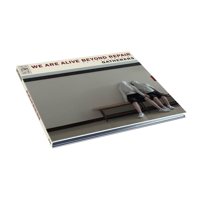 The We Are Alive Beyond Repair vinyl record cover by Gatherers features two people in Monochrome Coats, sitting on a bench with their heads covered by shirts, set against a plain wall.