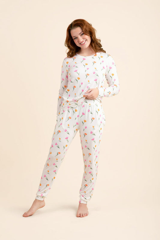 Female modeling the Women's Jogger Pajama Set in Tulip posing in front of a light neutral background