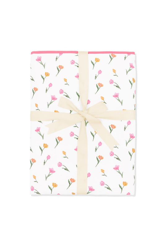 Youth Blanket in Tulip 1.0 shown in its packaging tied with a linen bow