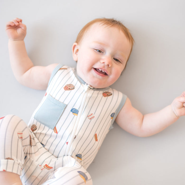 Close up of toddler wearing the Zippered Sleeveless Romper in Home Run